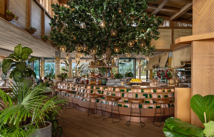 An artificial plumeria tree installed in a restaurant.
